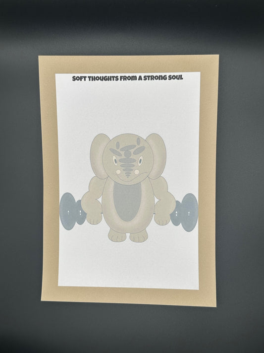 A notepad that has a brown character that is a rounded shape with muscles and has black eyes and a smile. The character is holding black weights. The notepad has brown edges all around the four corners and a notepad heading stating " Soft thoughts from a strong soul." The notepad is sitting on top of a black background.