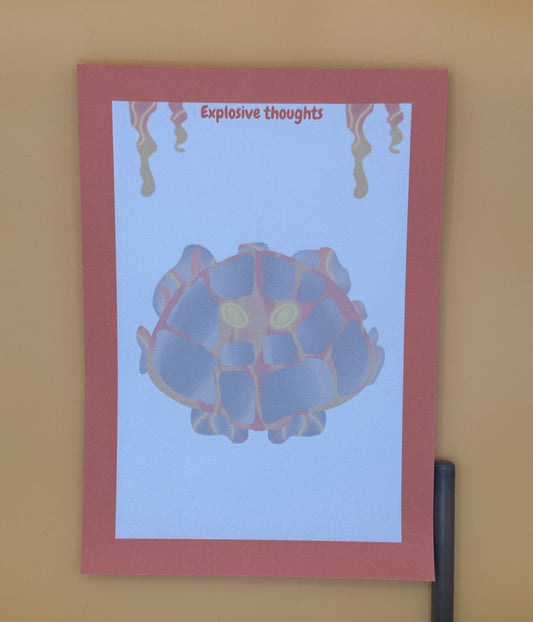 A notepad that has rocks and orange and red lava coming from it. The lava character has yellow eyes. The notepad has orange edges all around the four corners and has lava coming down from the top of the notepad. The notepad has a heading of " Explosive thoughts." The notepad is sitting on top of an orange background with a pen.