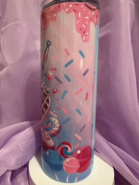 A tall, skinny tumbler decorated with an illustration of a heart-shaped waffle cone filled with blue and pink swirled ice cream, topped with a large red heart and sprinkles.