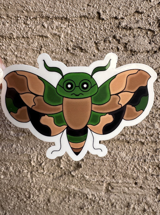 A fictional character sticker that has camouflage color that is an animal wasp shape and has black colored glasses. 