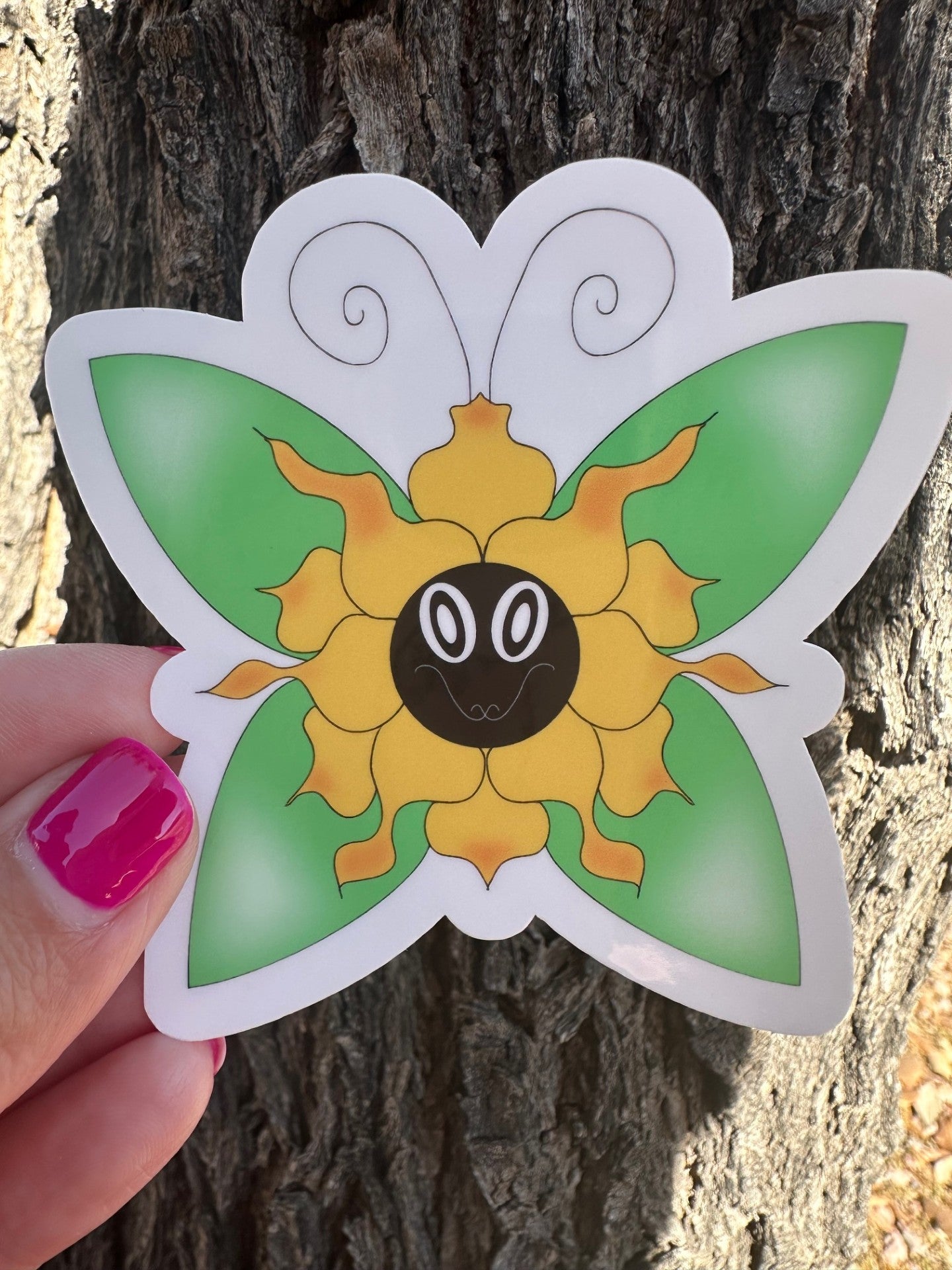 Hand-drawn whimsical flower character that is yellow with orange hues, with a face and a vibrant green butterfly perched on a rustic tree branch.