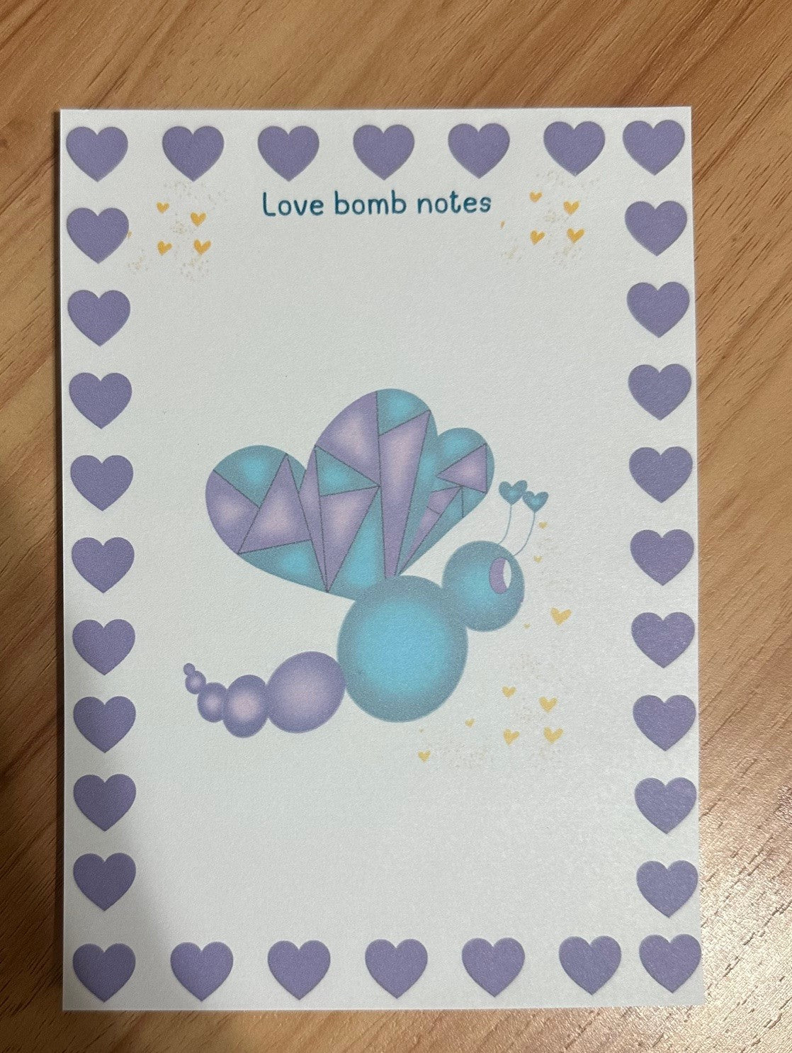 Notepad titled "Love Bomb Notes" features the character Love Mist, which has a purple and deep green color with yellow hearts falling from it.