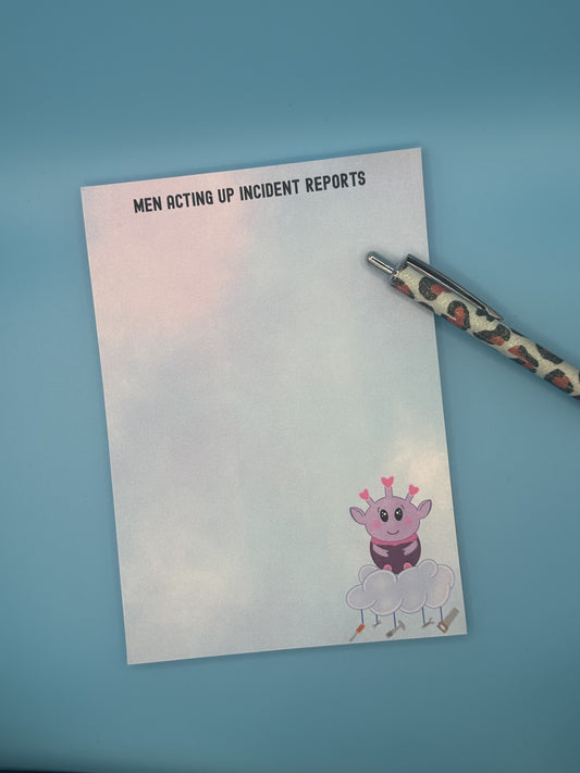 Notepad with a cartoon character at the bottom right of the notepad. The character looks like an alien who is purple and is sitting on top of a cloud with tools hanging from it. The notepad has a pastel-colored background, and on top of the notepad states 'Men Acting Up Incident Reports'. The notepad is sitting on a blue background with a pen. 