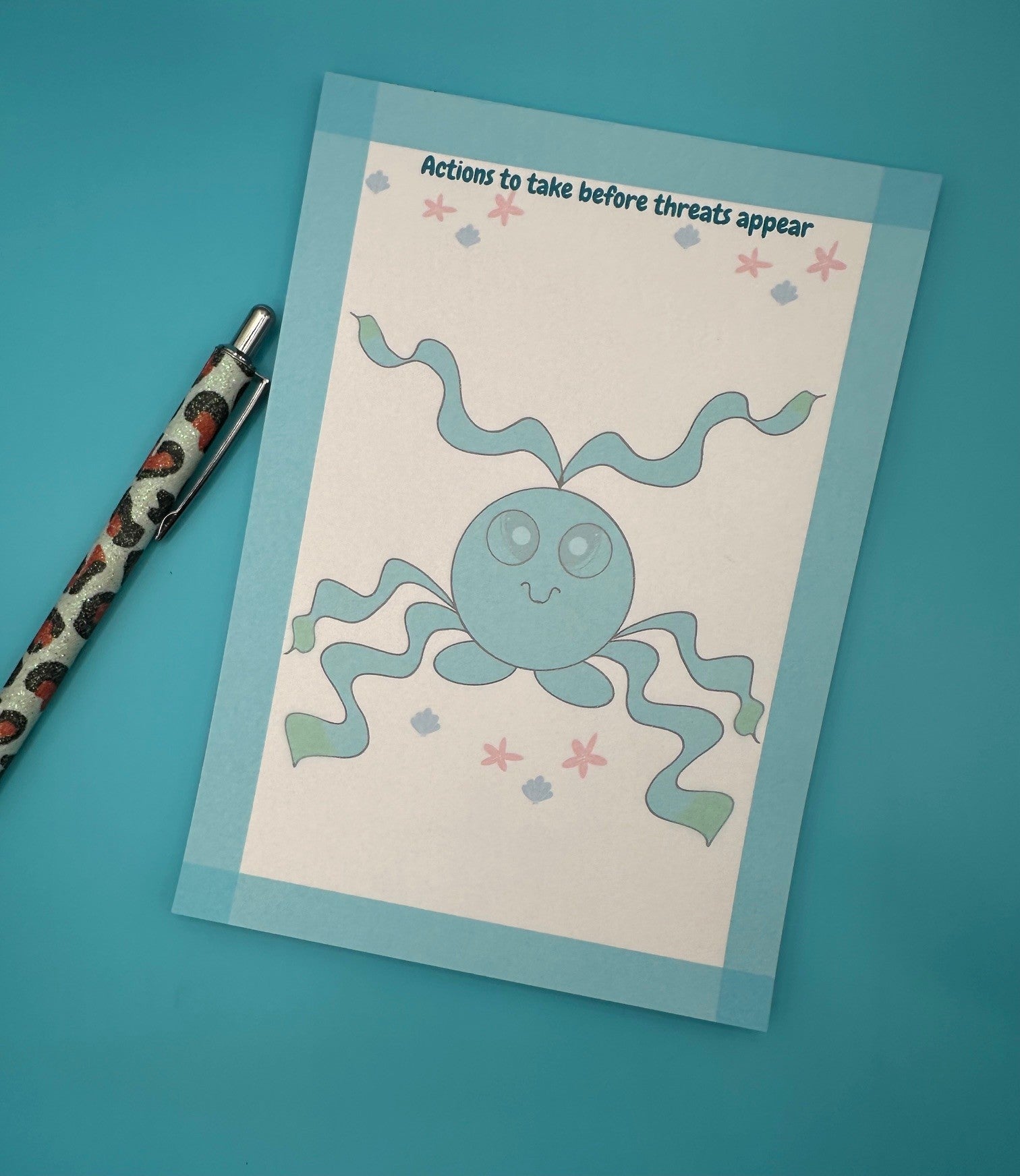 A notepad with a blue shape character that has tentacles coming from it with big blue eyes with shells on the bottom and starfish. Around the edges of the notepad is a blue color with a notepad heading of "Actions to take before threats appear". The notepad is sitting on top of a blue background with a pen. 