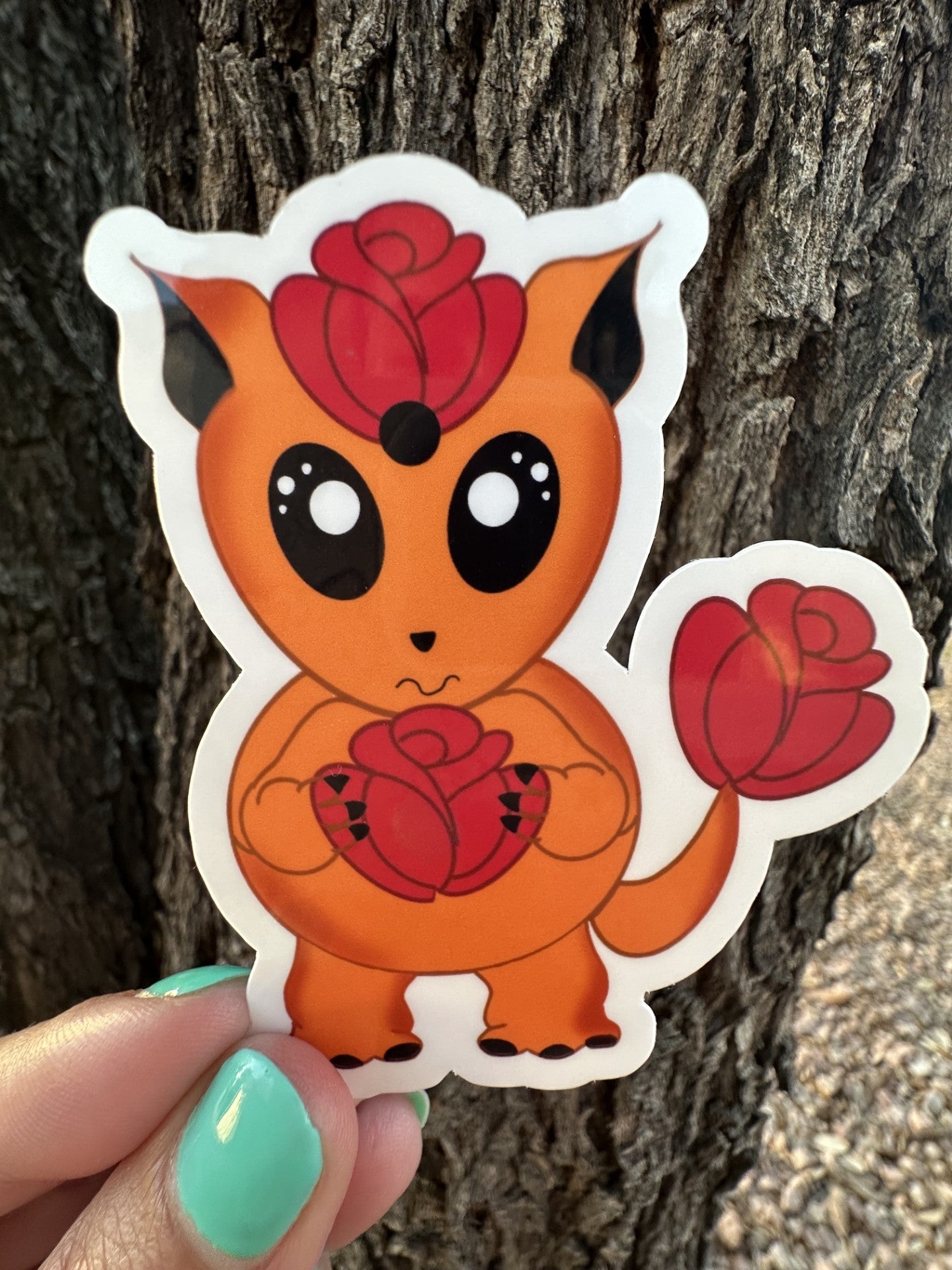 Orange cartoon sticker character with red roses against a tree bark background. The character is holding a red rose and has a red rose on top of the head and has one on the tail.