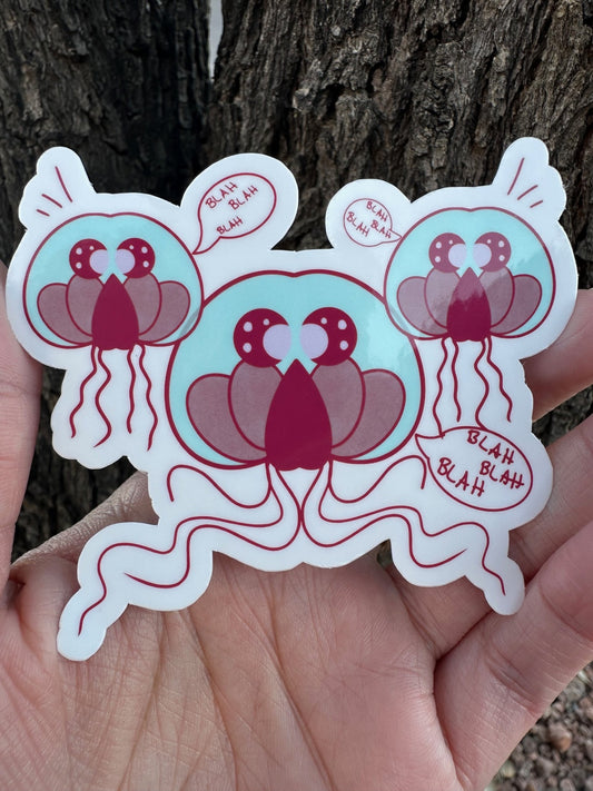 A sticker featuring three cartoon jellyfish-like creatures in teal and maroon colors with multiple speech bubbles that all say 'BLAH BLAH BLAH'.