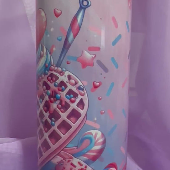 A tall, skinny tumbler decorated with an illustration of a heart-shaped waffle cone filled with blue and pink swirled ice cream, topped with a large red heart and sprinkles.