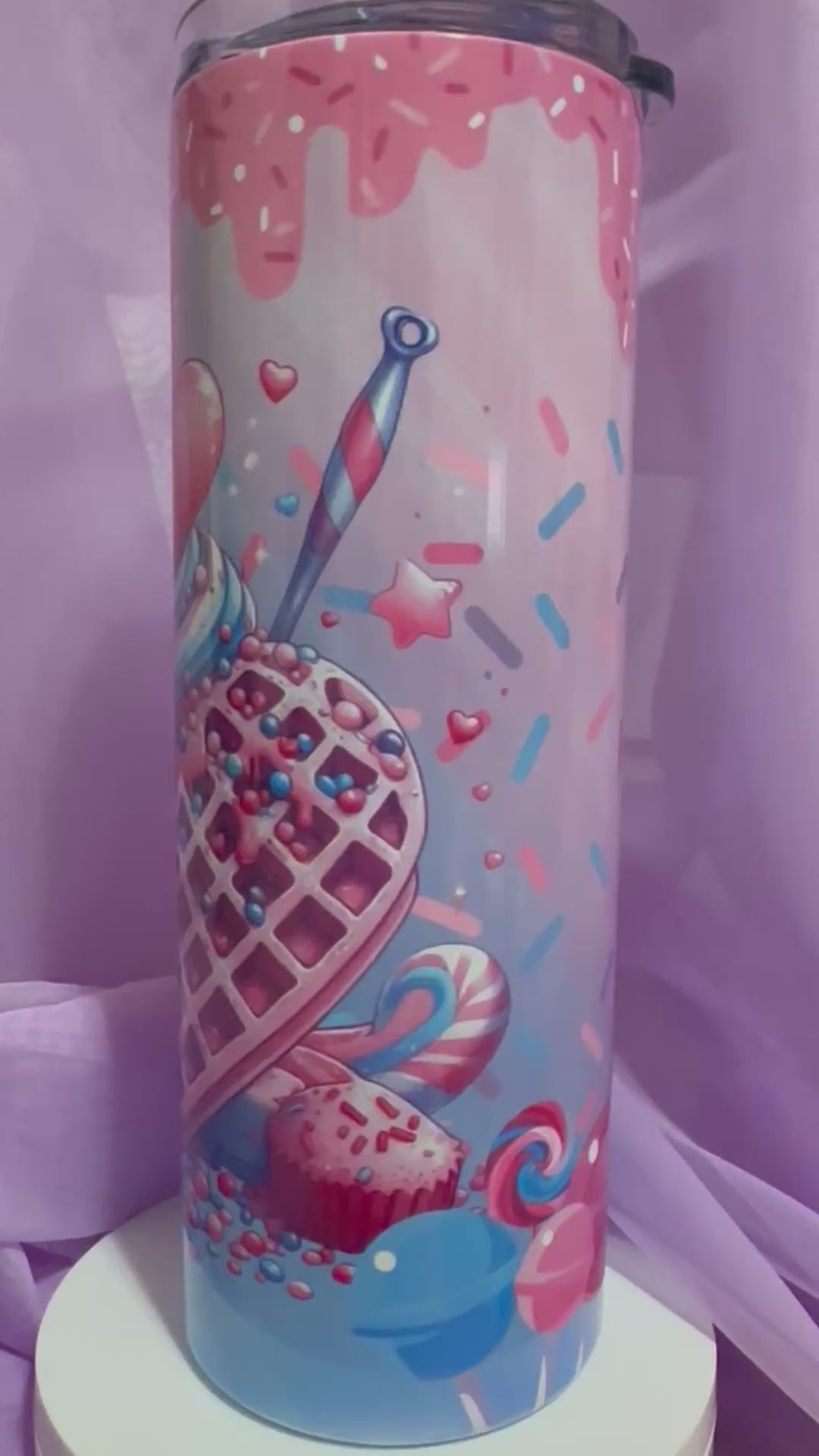 A tall, skinny tumbler decorated with an illustration of a heart-shaped waffle cone filled with blue and pink swirled ice cream, topped with a large red heart and sprinkles.